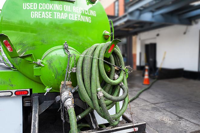 grease trap pumping truck with hose in Bartlett TX